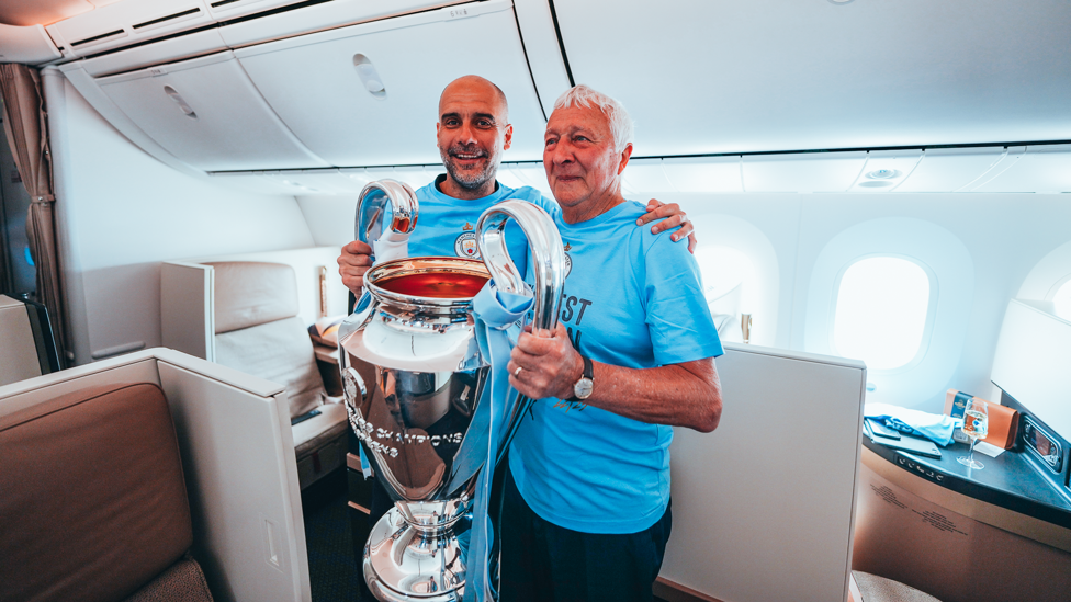 LEGENDS  : Guardiola and Mike Summerbee pose with the European Cup on the way back to Manchester.