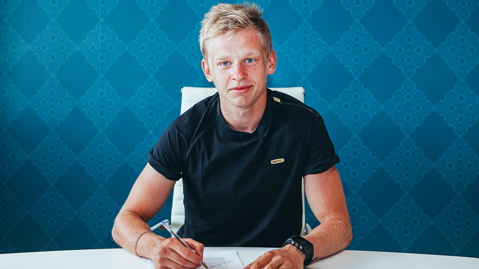 SIGN HERE: Oleksandr Zinchenko proudly puts pen to paper as he joins City in the summer of 2016