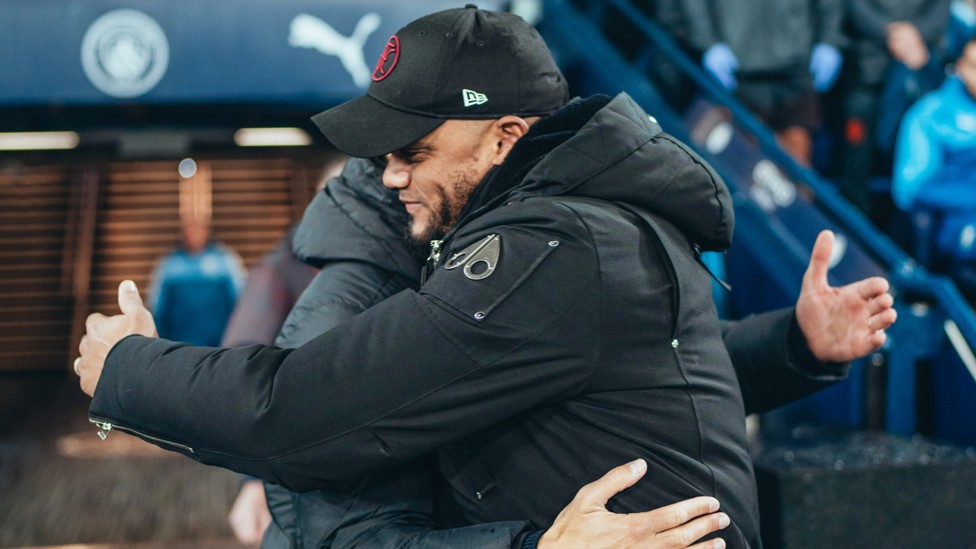 BOSSES : Guardiola and City legend Kompany share a warm embrace ahead of kick-off.