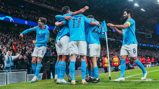 CELEBRATE: The players celebrate the second goal.