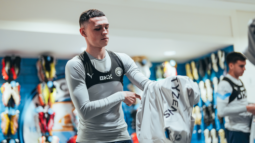 READY TO RETURN : Phil Foden prepares to go out onto the pitch.