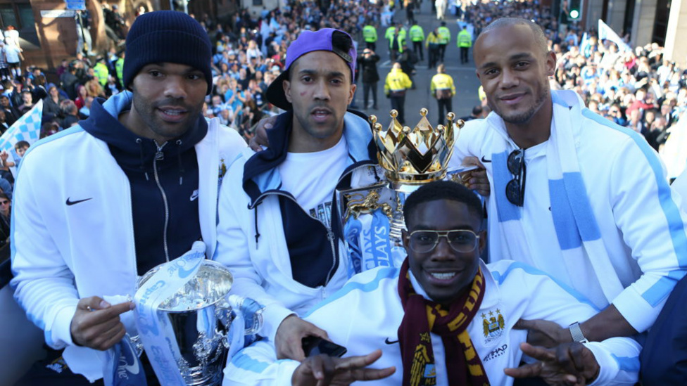 WINNERS : Alongside his defensive colleagues at the 2014 champions parade.