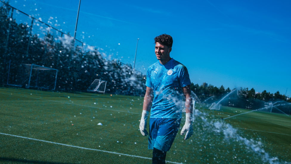 SPLASH HIT: George Murray-Jones framed by the CFA sprinkler system!