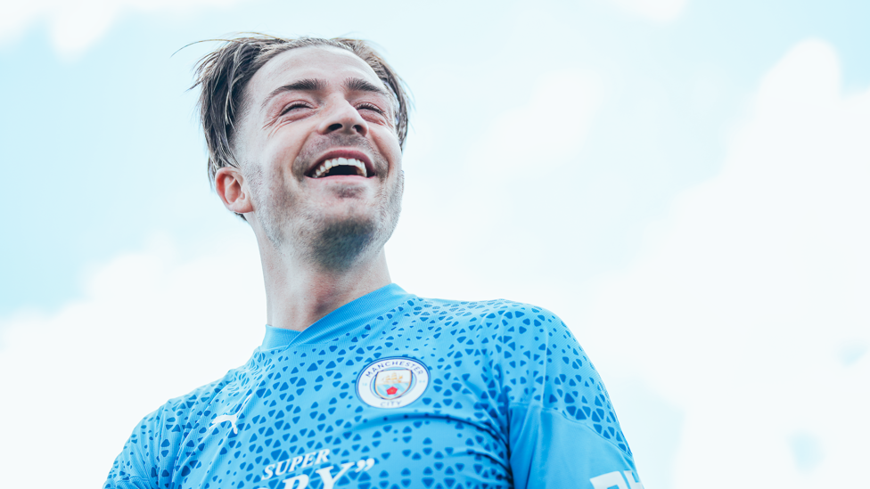 ALL SMILES : Grealish in a positive mood before City flew to Asia.