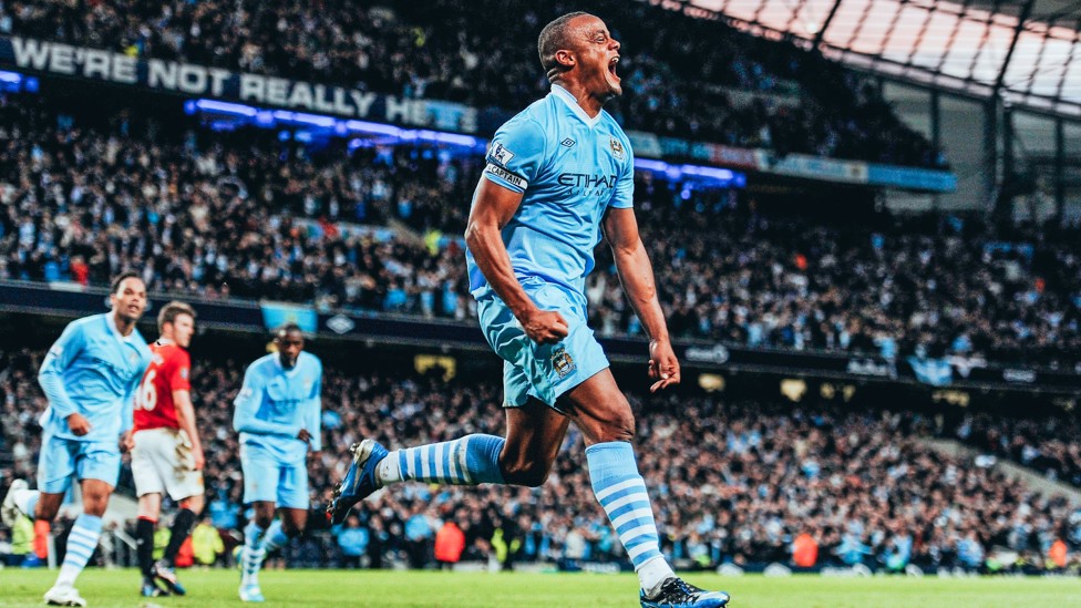 GOOD KOMPANY : Vincent Kompany wheels away after scoring a decisive goal in the 2011/12 title race - the winner in the Manchester derby