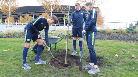 Academy players Harvey Griffiths, Tom Midfley and Katie Bradley plant the trees