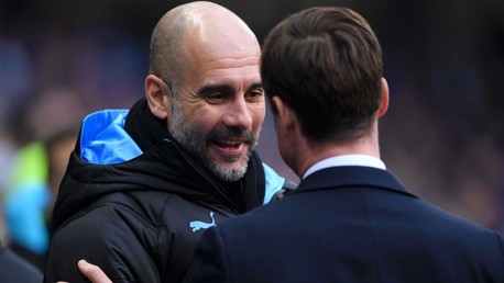 GAFFERS: Guardiola and Parker share a warm embrace ahead of kick-off.