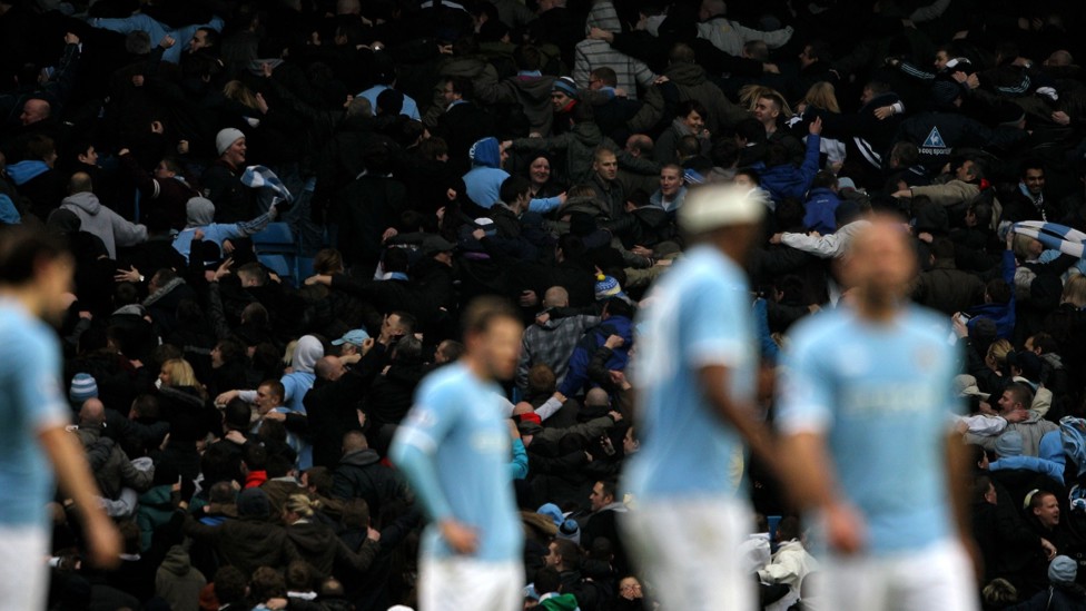 BACKING THE BLUES : Fans do the 'Poznan' - a new show of support which involves turning your back on the pitch, spreading your arms and grabbing the person next to you