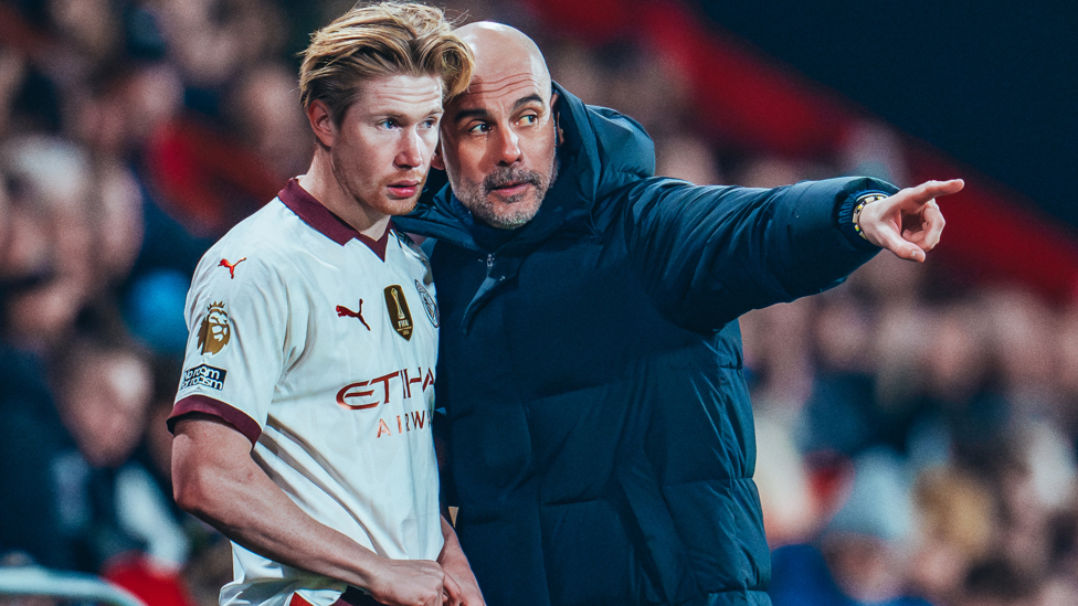 KING KEV : Pep Guardiola gives Kevin De Bruyne instructions before taking to the pitch,