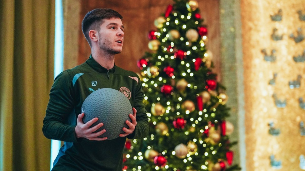 JAMES MCATEE : The Academy graduate working out in front of a Christmas tree