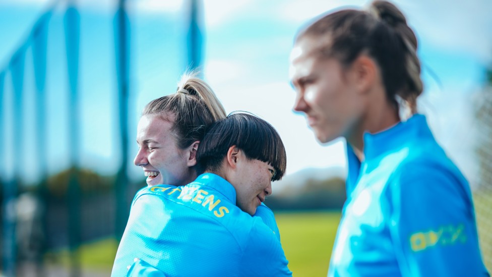 FOOTBALL FRIENDS : Lauren Hemp and Aoba Fujino share a hug. 