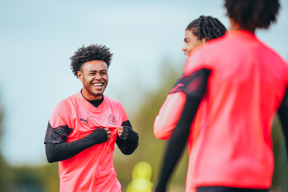 ALL SMILES  : Tai Sodje shares a joke with his teammates. 