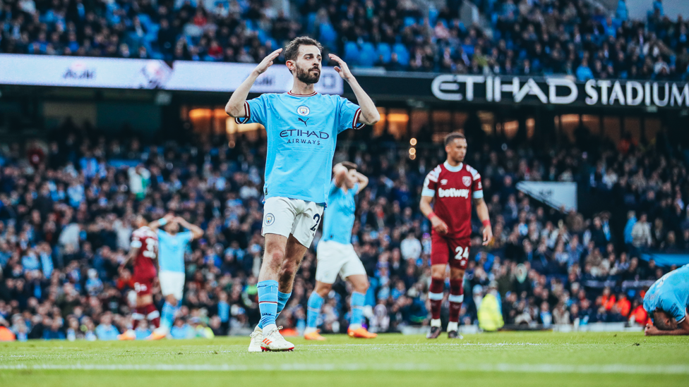 CLOSE : Bernardo reacts after Rodri's strike hits the post just after the half-hour mark.