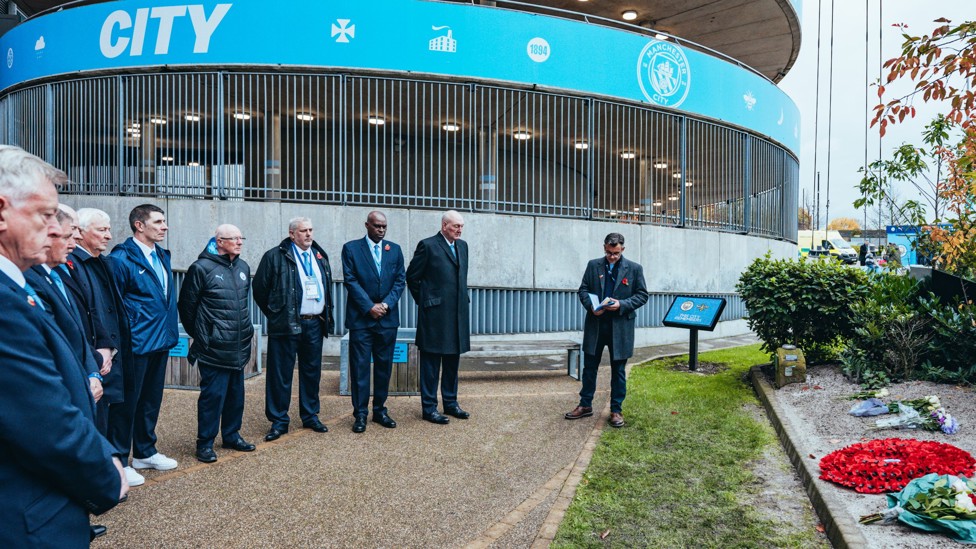 MANCHESTER REMEMBERS : Club Ambassador Mike Summerbee and several former players pay their respects for the service and sacrifice of the Armed Forces community in the Memorial Garden at the Etihad Stadium.