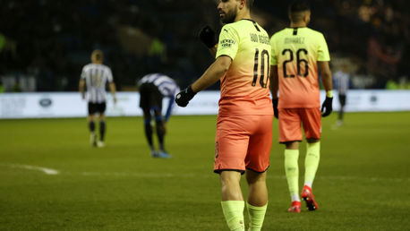 KING OF MANCHESTER: Aguero taps the badge in front of the fans!