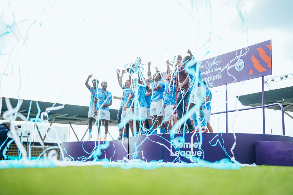 ON STAGE : The team celebrate with the trophy in front of the fans.