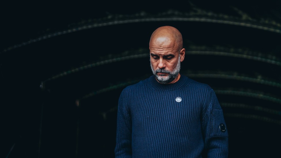 DEEP IN THOUGHT : Pep Guardiola checking out the warm-ups with kick-off approaching