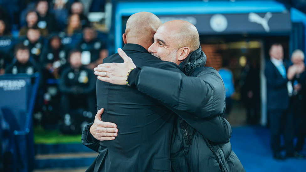 FAMILIAR FACE  : Guardiola and Vincent Kompany embrace ahead of our meeting with the Belgian's Burnley in the FA Cup..