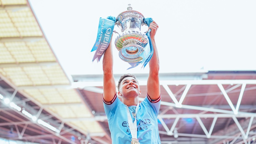 HISTORIC  : The Argentine lifts the FA Cup after a 2-1 win over Manchester United at Wembley.