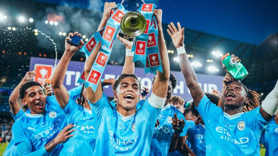 YOUNG BLUES : Jahmai Simpson-Pusey raises aloft the 2023/24 FA Youth Cup at the Etihad Stadium following our 4-0 victory over Leeds.