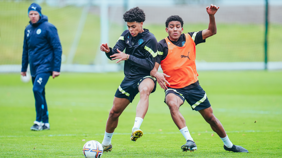 SHOULDER TO SHOULDER : Ezra Carrington and Jahmai Simpson-Pusey battle for possession