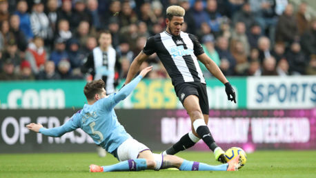 SLIDE AWAY: John Stones straining every sinew to reclaim possession 