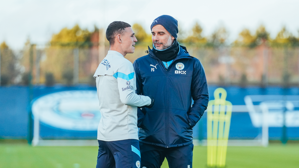 CATCH UP : Phil Foden and Pep Guardiola have a chat back on the training pitch