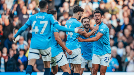 AMAZING ASSIST: Nunes is mobbed after his role in the goal.