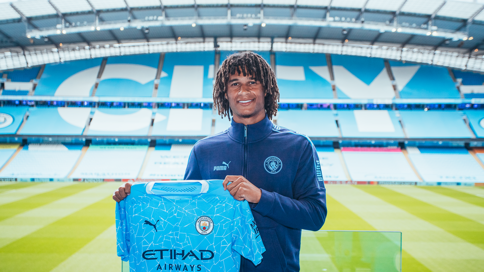 TRUE COLOURS: The Dutch defender poses at the Etihad after moving to the Club