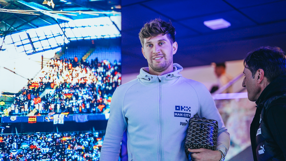 JOYOUS JOHN: John Stones walks towards the dressing room in a great spirit.