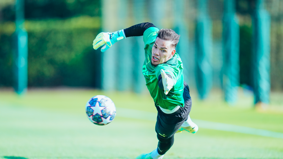 SAFE HANDS  : Ederson flings to his left to make a great save.