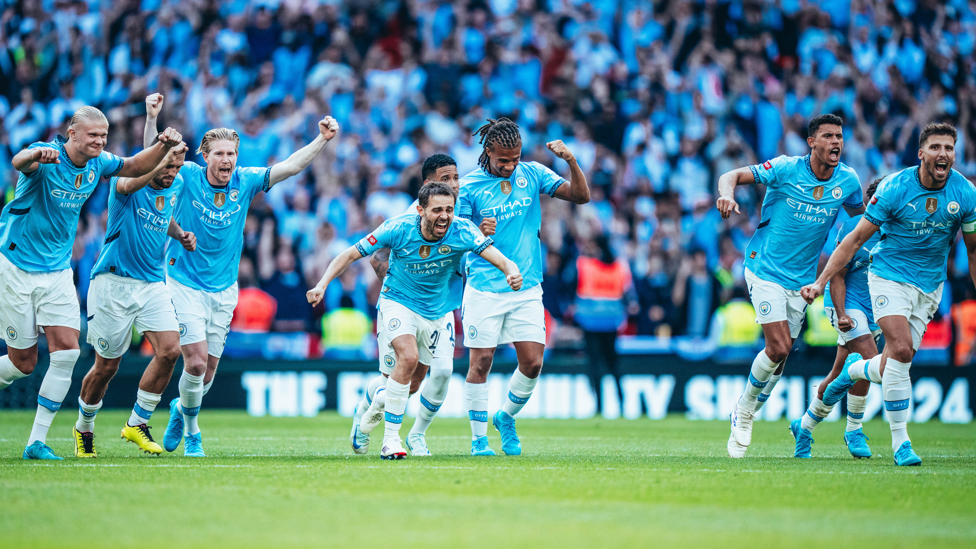 WINNERS : The players celebrate after winning 7-6 on penalties.