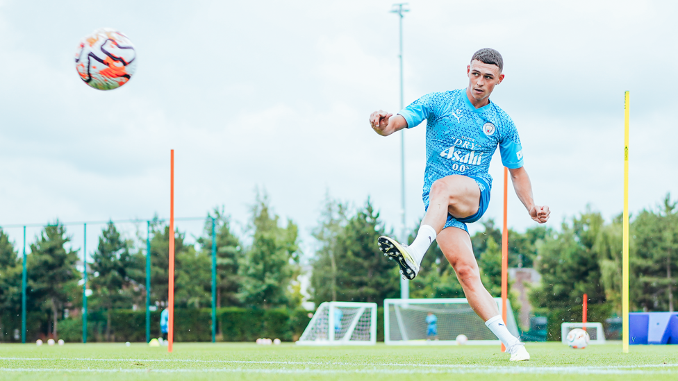 PRECISION  : Phil Foden curls an exquisite effort towards goal.