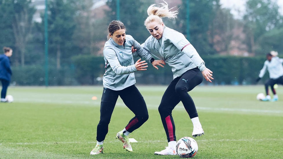 HARD YARDS : Hayley Raso and Alex Greenwood battle for the ball