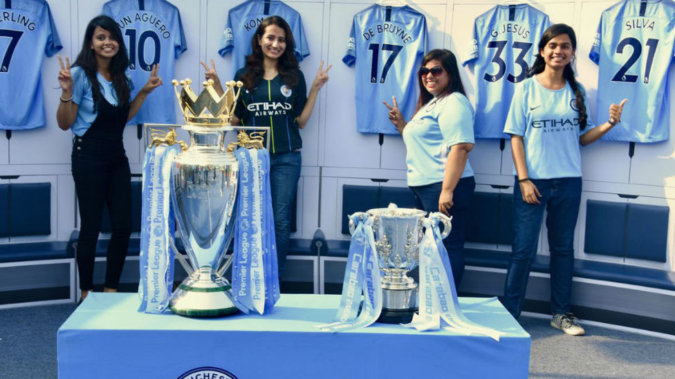 MOMENT TO REMEMBER : Supporters in Mumbai pose with the trophies