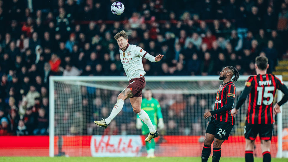 JUMPING JOHNNY : Stones rises highest to win a header as City defend Bournemouth's attacks.