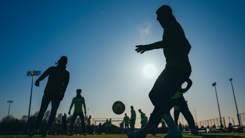 SHADOW  : City's players keep the ball in the air while basking in the Manchester sunshine. 