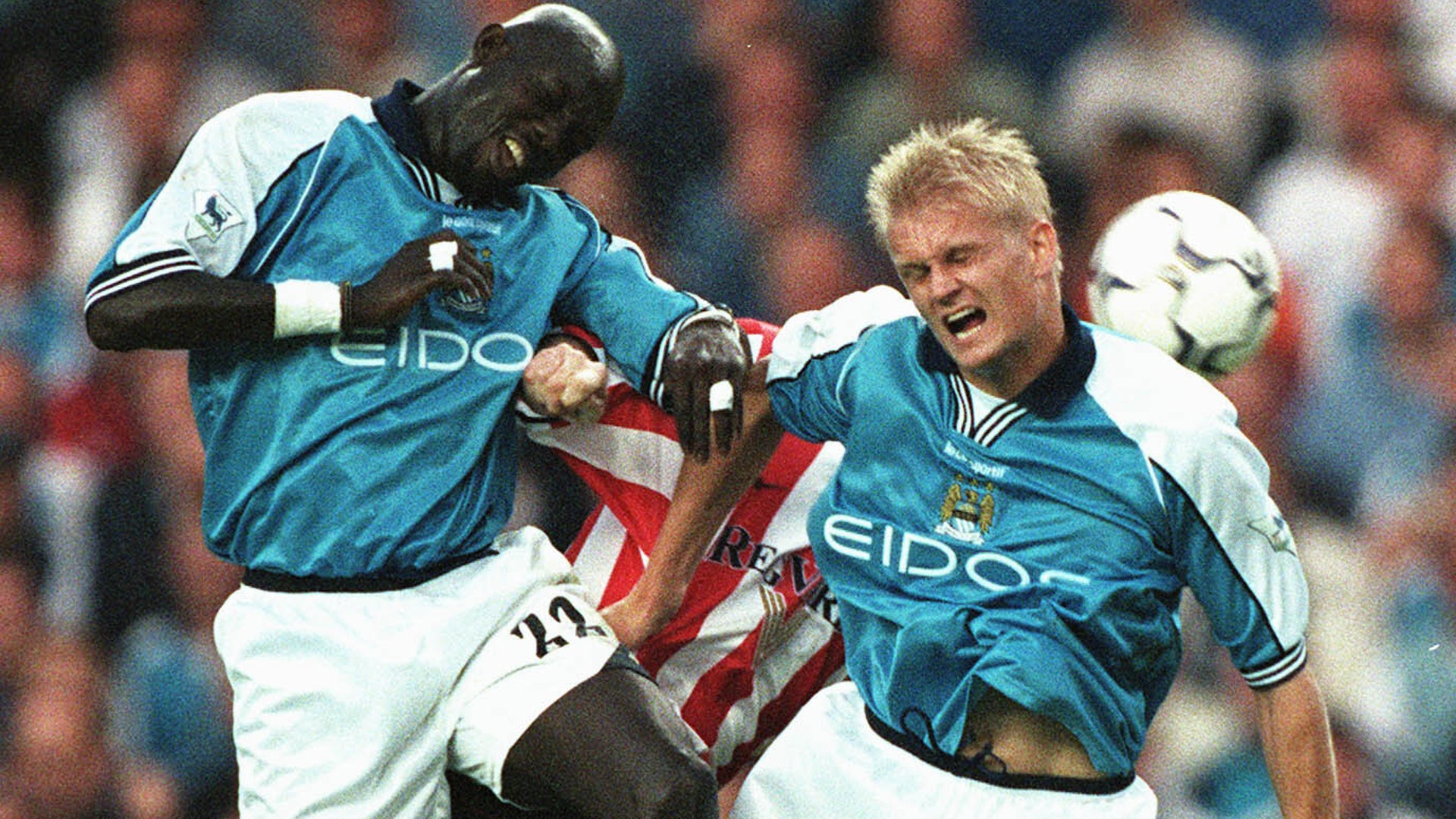 UP AND AT 'EM: George Weah in action for City alongside Alf-Inge Haaland.