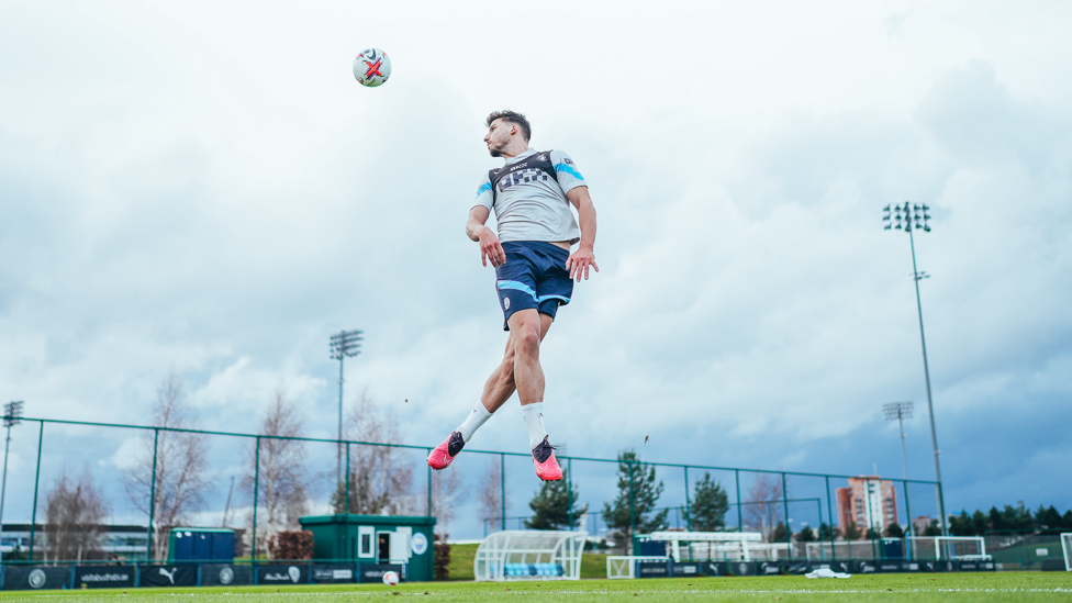 DIVING DIAS : Ruben Dias leaps to attack the ball as attention turns to the weekend