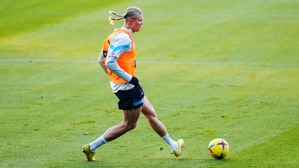 PASS AND MOVE : Erling Haaland passes the ball during the session 