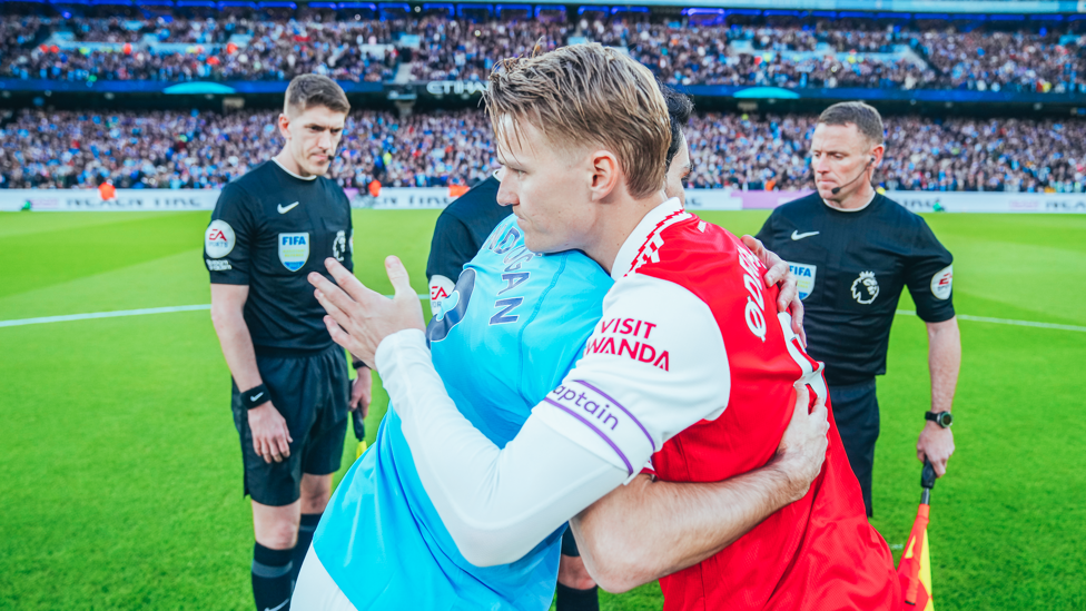 RESPECT : The skippers share a warm embrace ahead of kick-off.