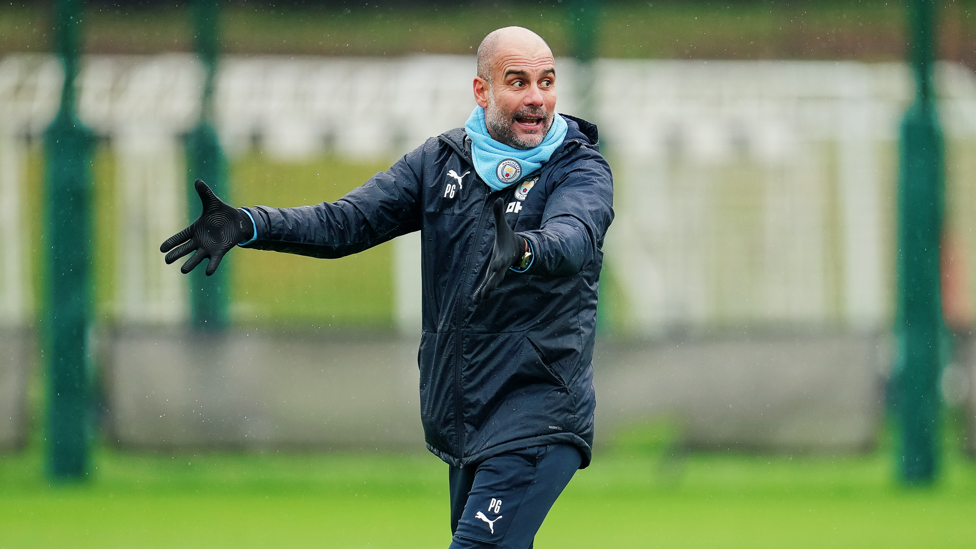 PEP TALK : Pep Guardiola passes on instructions to his players 