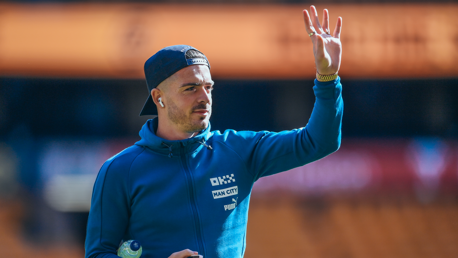 Jack Grealish checks out the Molineux surface