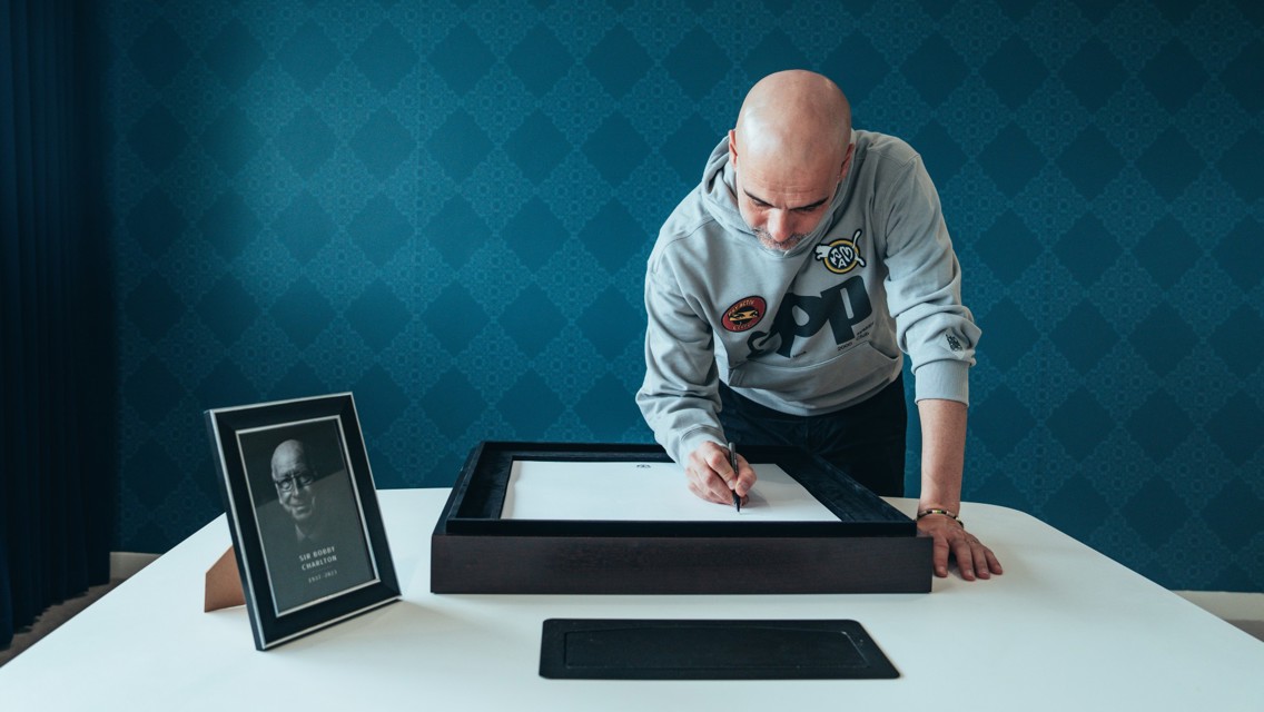 Pep signs book of condolence for Sir Bobby