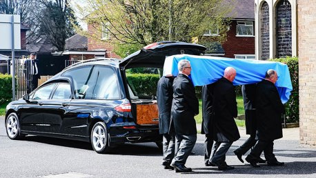 Bernard’s coffin was draped in sky blue, adorned with lilies.