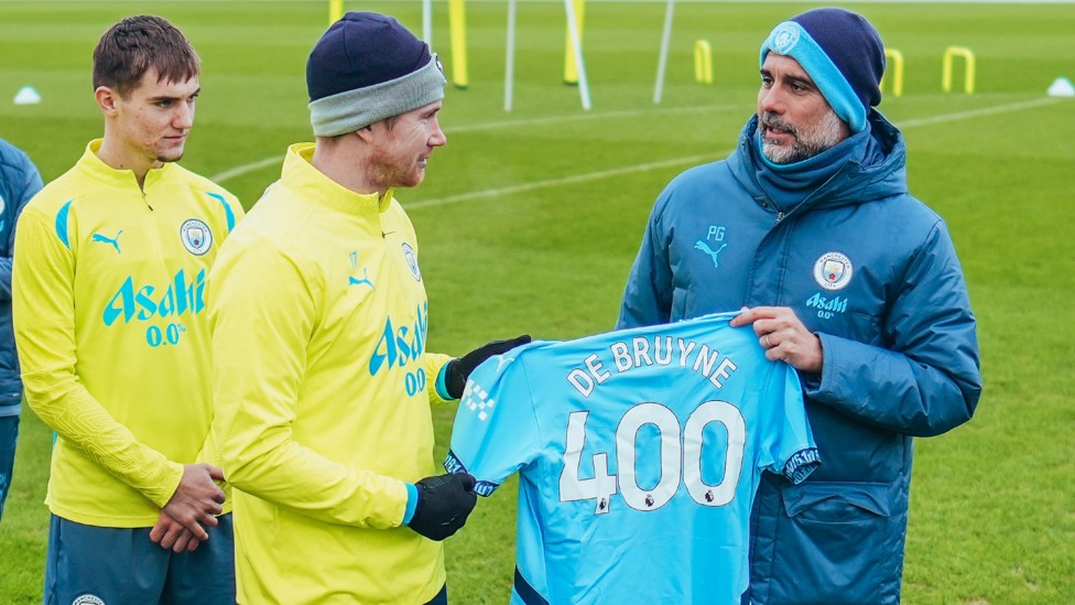 CONGRATULATIONS : Pep Guardiola gifts Kevin De Bruyne a special shirt to celebrate his 400th appearance for the Club.