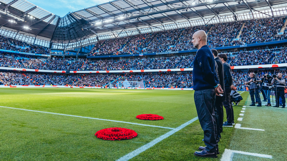 CITY REMEMBERS : Pep Guardiola and Russell Martin place wreaths on the Etihad pitch.