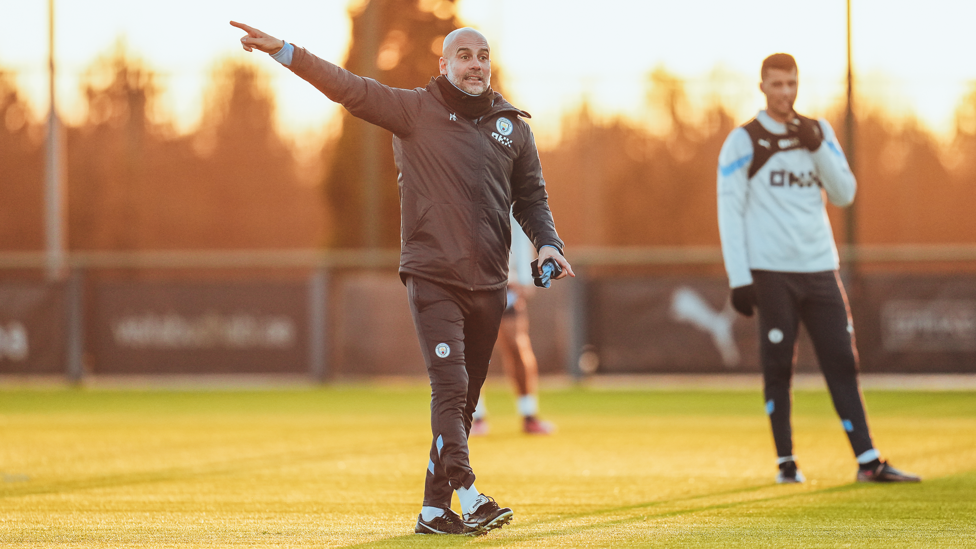 ON POINT : Pep gives his instructions as the sun goes down in Manchester