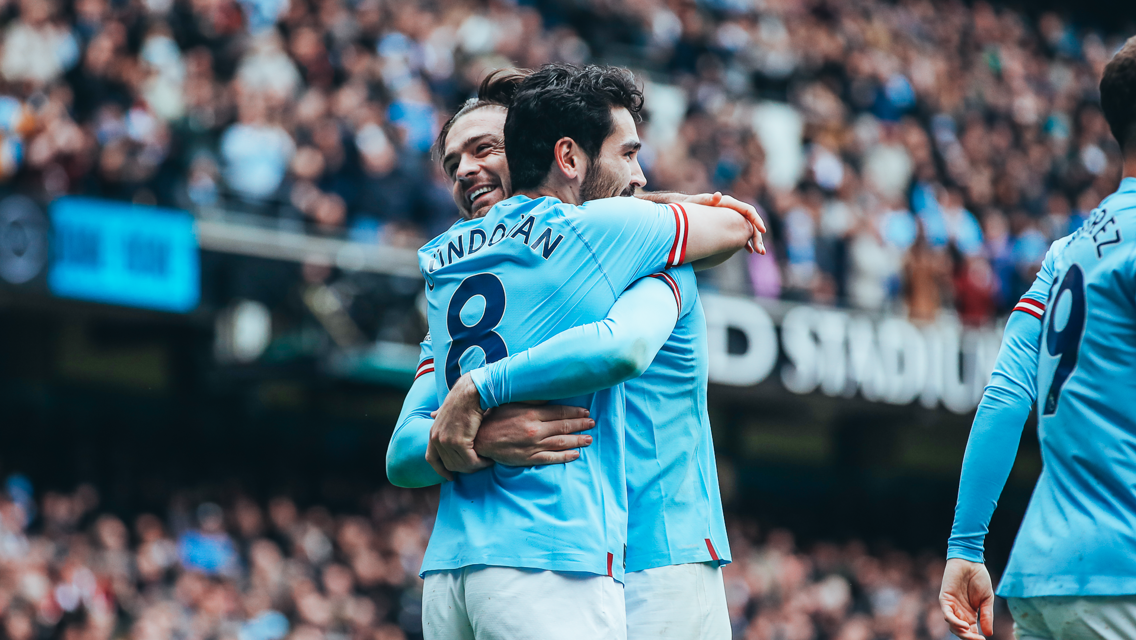 COUPLE OF Gs: Grealish gives a big hug to Gundogan.