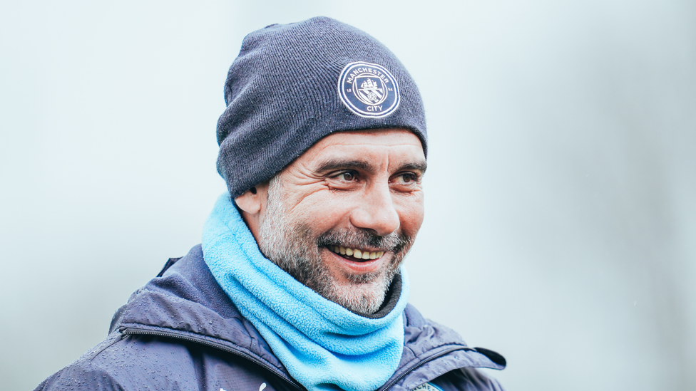 GRINNING GUARDIOLA : Pep wraps up warm